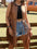 Woman wearing a Tan Western Cowgirl Fringe Vest Coat over jeans shorts