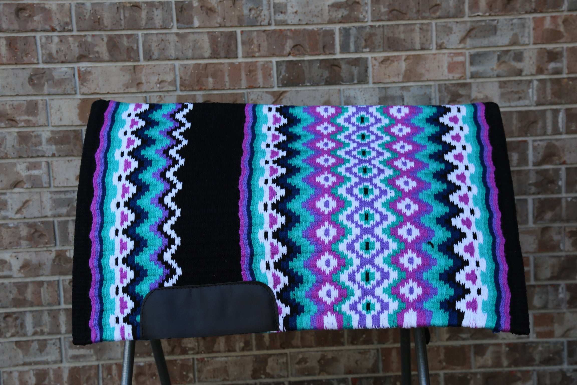 Custom Western Saddle Pad in Blue, Purple, Teal, Black geometric design and colors| Limited Edition displayed on saddle rack