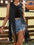 Woman wearing a Black Western Cowgirl Fringe Vest Coat over jeans shorts