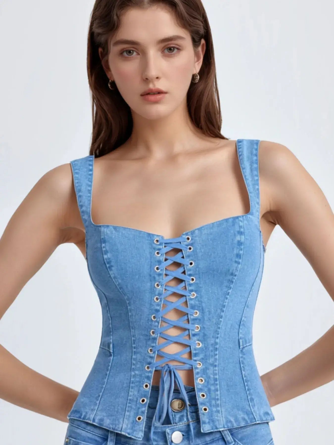 closeup Woman wearing a blue denim corset on a white background