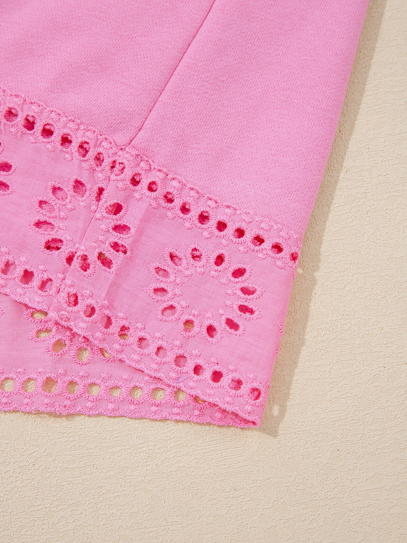 eyelet details of a pink Eyelet Lace Snap Button Sweatshirt