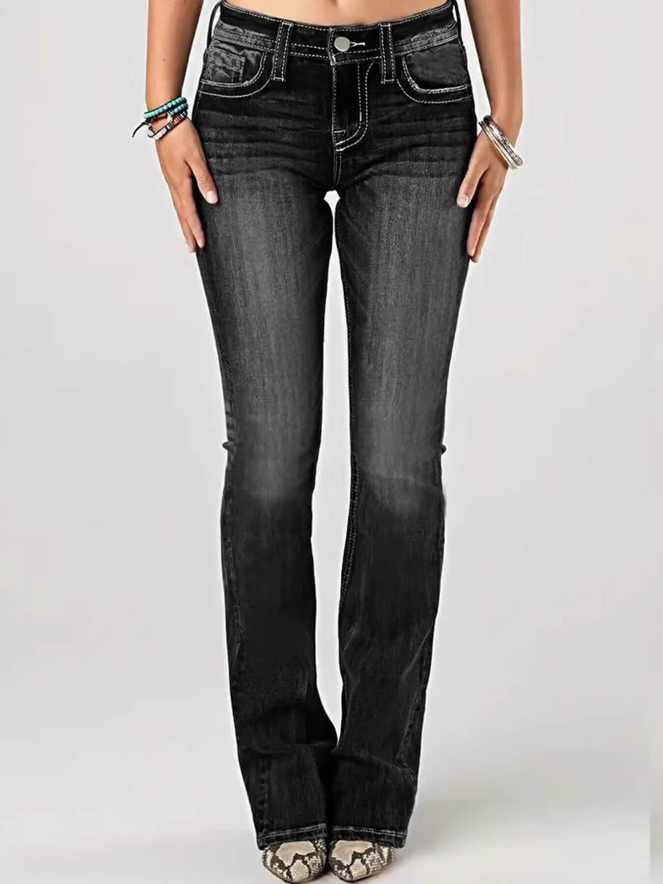 Black jeans worn by a person on a white background